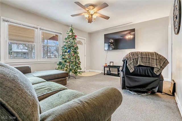 carpeted living room featuring ceiling fan