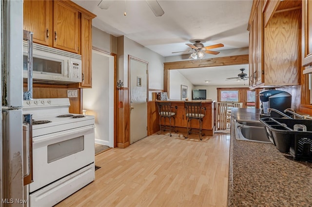 kitchen featuring light wood-type flooring, white appliances, ceiling fan, and sink