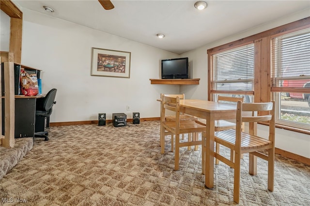 dining room with carpet, vaulted ceiling, and a wealth of natural light