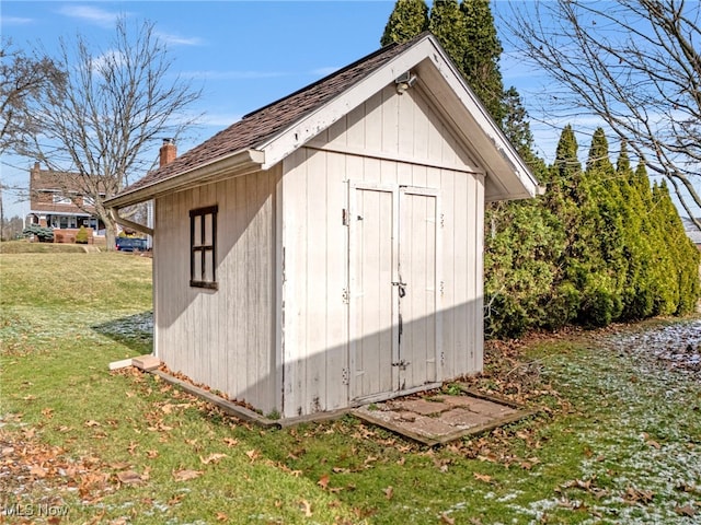 view of outdoor structure featuring a lawn