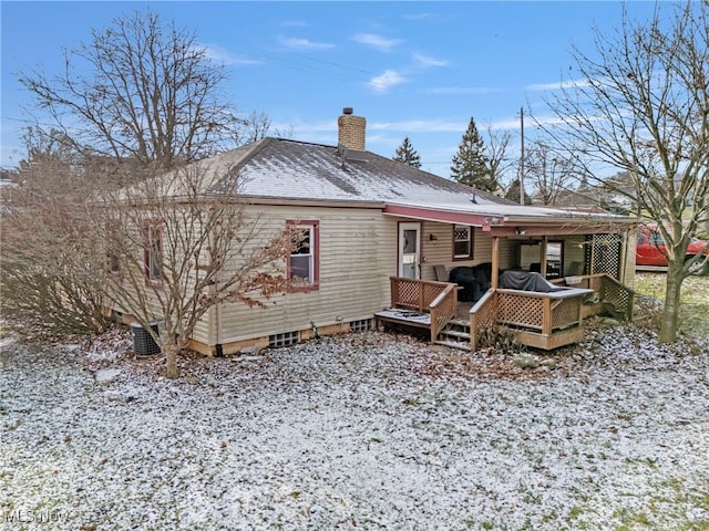 snow covered property with a deck and cooling unit