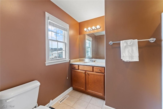 bathroom featuring tile patterned flooring, vanity, and toilet