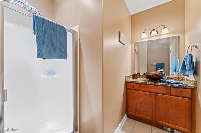 bathroom with tile patterned floors, a shower with door, and vanity