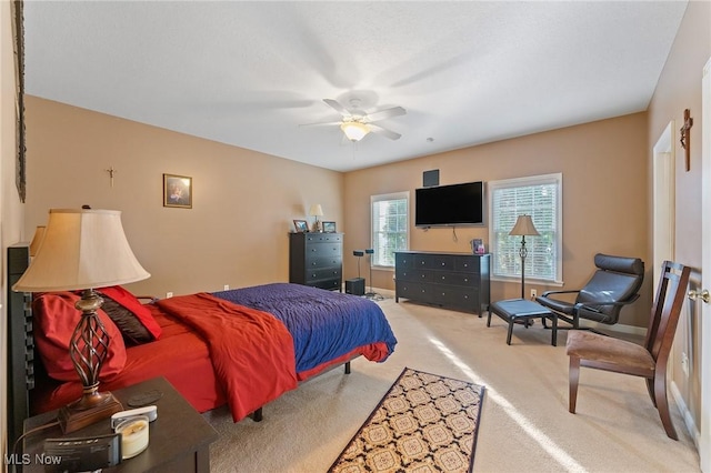 bedroom featuring light carpet and ceiling fan