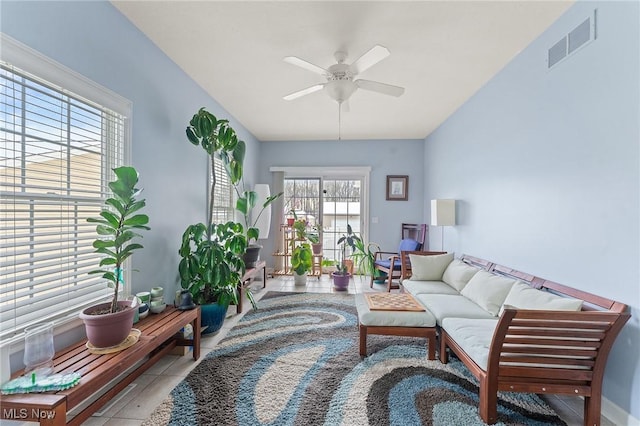 living room featuring light tile patterned floors and ceiling fan