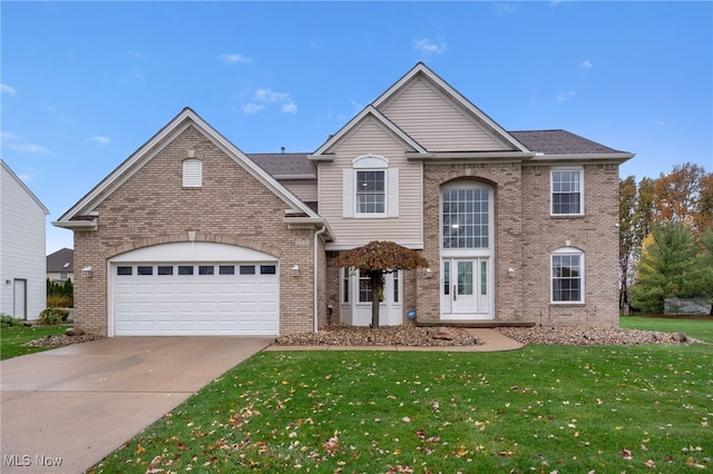 view of property featuring a front lawn and a garage