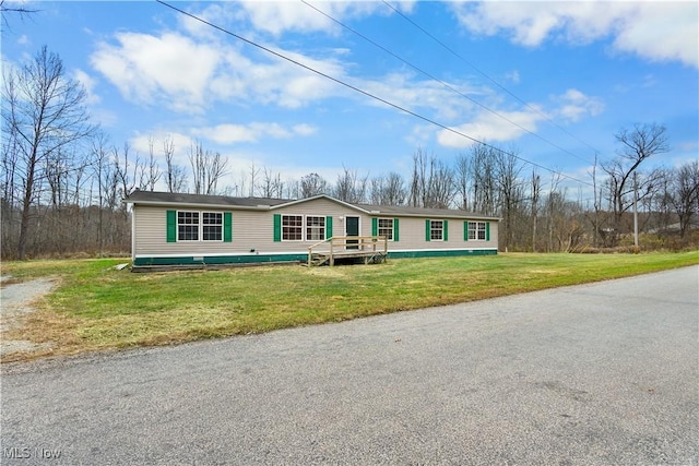 view of front of property with a deck and a front lawn