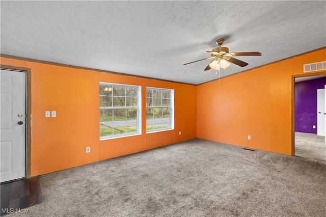 spare room with carpet, ceiling fan, lofted ceiling, and a textured ceiling