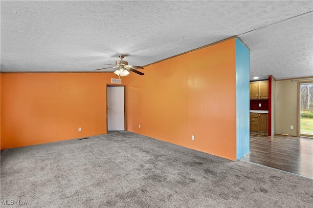 carpeted spare room with ceiling fan, a textured ceiling, and ornamental molding