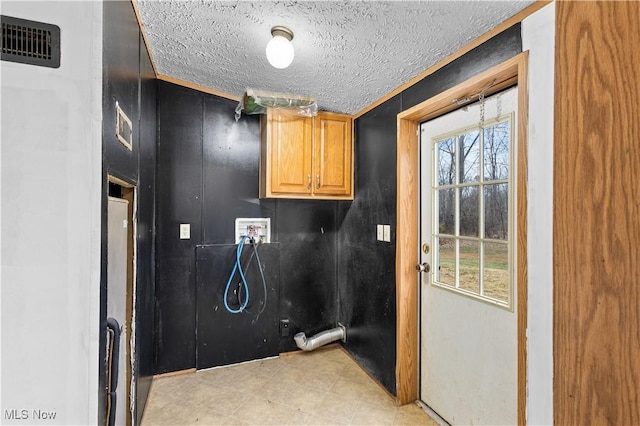 laundry room with cabinets, hookup for a washing machine, and a textured ceiling