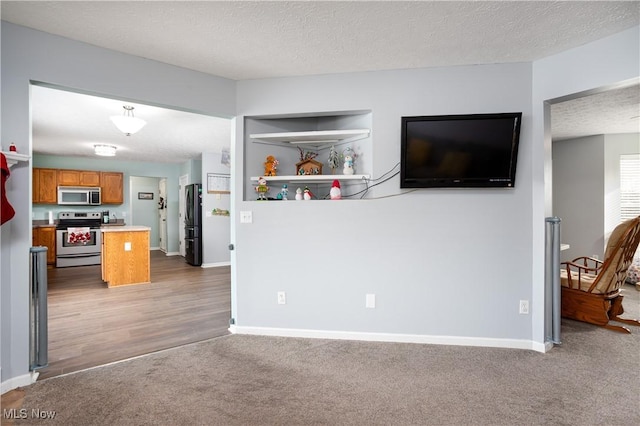 carpeted living room featuring a textured ceiling