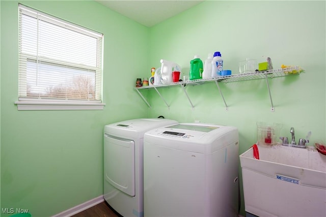 clothes washing area with washer and clothes dryer and sink