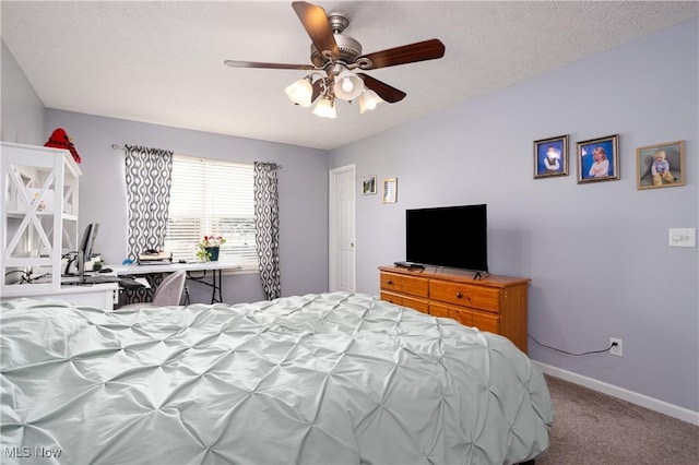 carpeted bedroom featuring a textured ceiling and ceiling fan