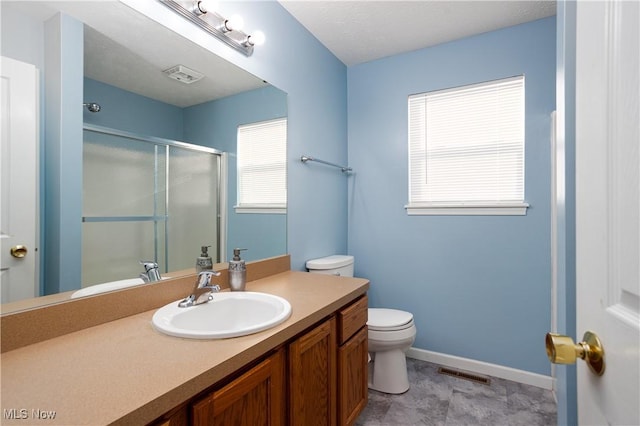 bathroom featuring vanity, toilet, and walk in shower