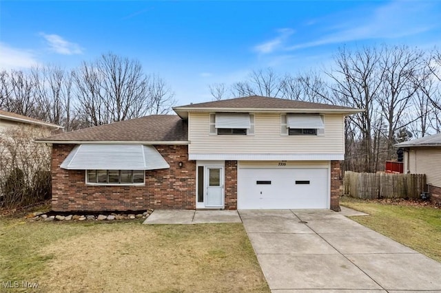 tri-level home featuring a front yard and a garage