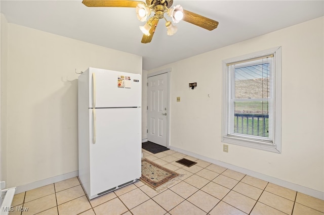 kitchen featuring ceiling fan, white refrigerator, and light tile patterned floors