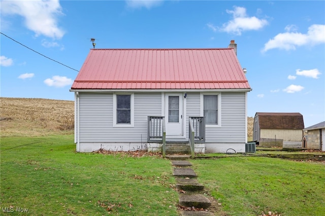 view of front of property featuring a front lawn and central air condition unit