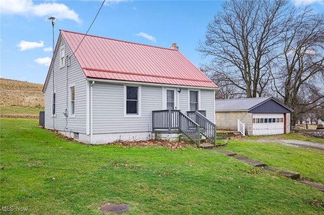 view of front facade featuring an outbuilding, a front yard, and a garage