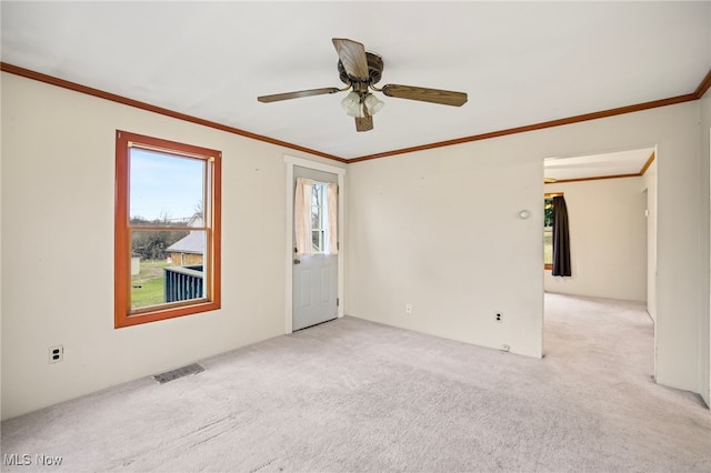 empty room with light carpet, plenty of natural light, and ceiling fan