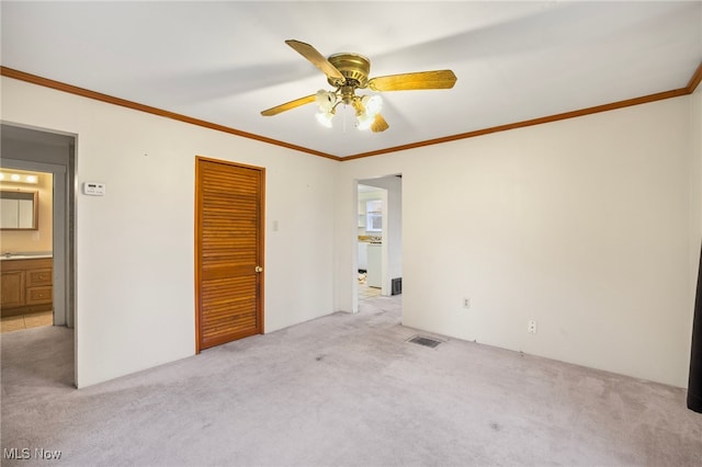 unfurnished bedroom with light carpet, a closet, ornamental molding, and ceiling fan