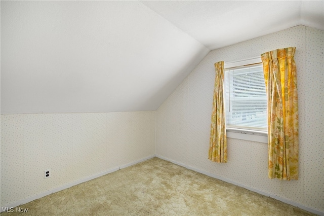 bonus room featuring light colored carpet and vaulted ceiling