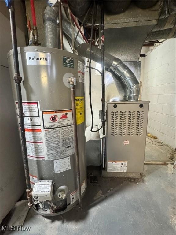 utility room featuring water heater and heating unit