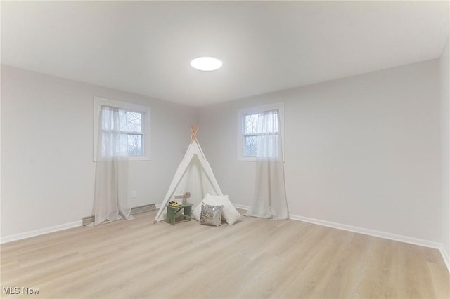 game room with light hardwood / wood-style flooring