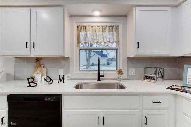 kitchen with decorative backsplash, light stone counters, sink, dishwasher, and white cabinetry