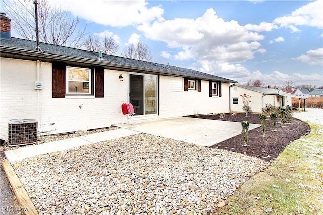 rear view of house featuring a patio and central AC