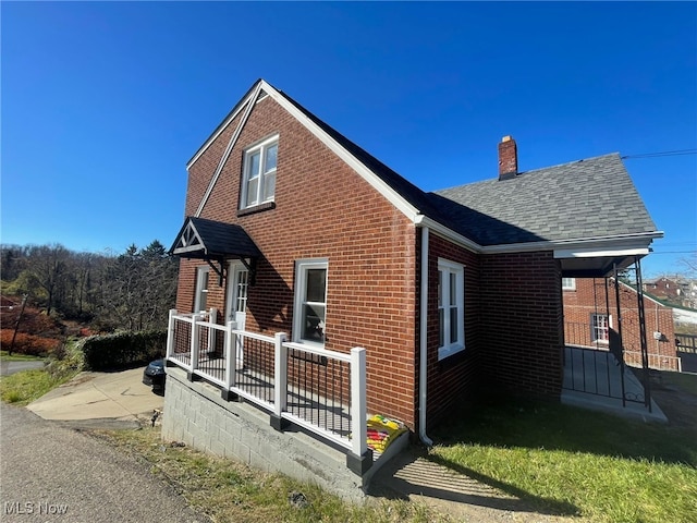 view of side of property with covered porch