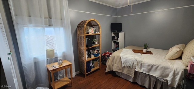 bedroom with crown molding and dark wood-type flooring