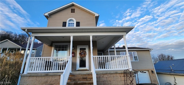 view of front of property featuring a porch and a garage