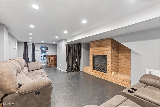 living area featuring a brick fireplace, finished concrete floors, and recessed lighting