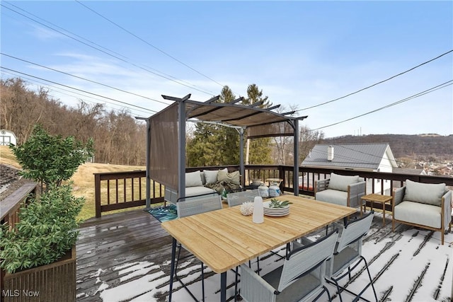 deck with outdoor dining area, a pergola, and an outdoor living space