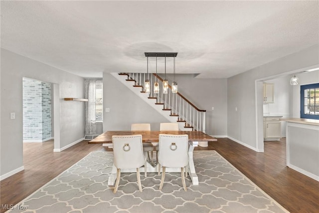 dining area with stairs, dark wood-style flooring, and baseboards