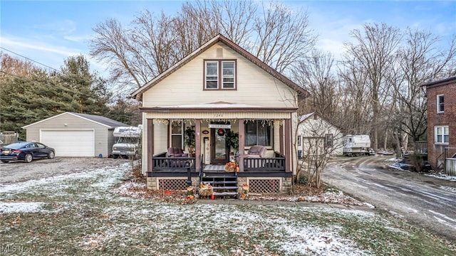 bungalow-style house with an outbuilding, a porch, and a garage