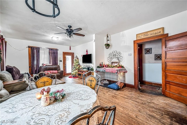 dining space featuring hardwood / wood-style flooring, ceiling fan, and a textured ceiling