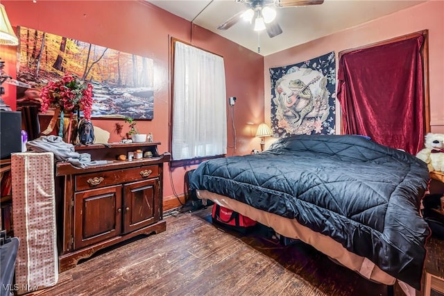 bedroom featuring ceiling fan and dark hardwood / wood-style floors