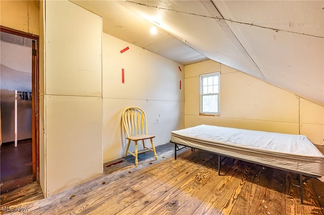 bedroom featuring hardwood / wood-style floors and lofted ceiling