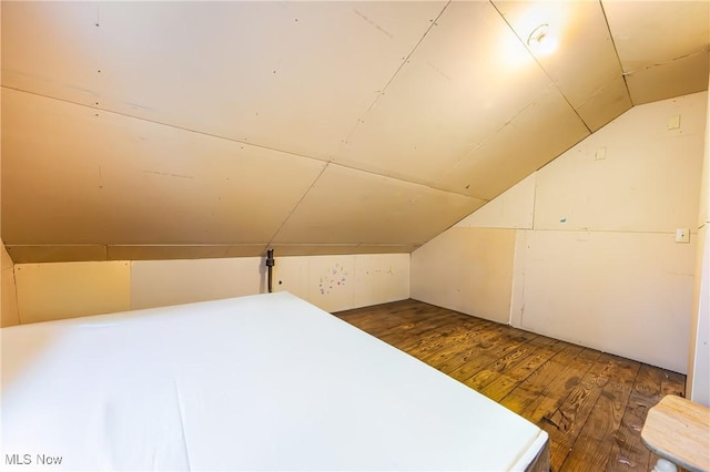 additional living space featuring dark hardwood / wood-style flooring and vaulted ceiling