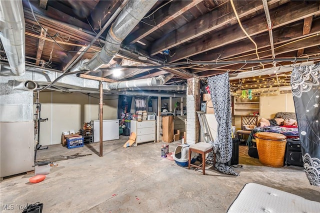 basement with refrigerator and heating unit