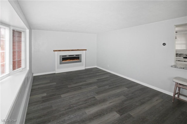 unfurnished living room featuring dark hardwood / wood-style flooring