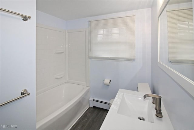 full bathroom with sink, shower / washtub combination, hardwood / wood-style flooring, toilet, and baseboard heating