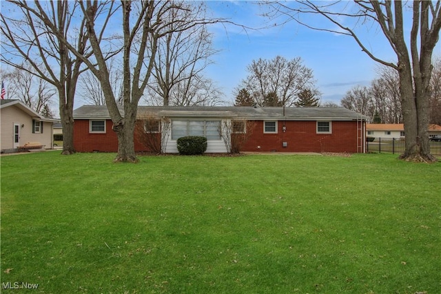 rear view of house with a yard