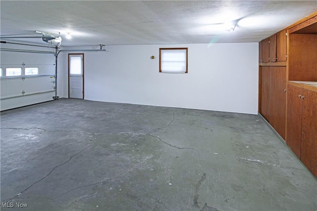 garage featuring wood walls and a garage door opener