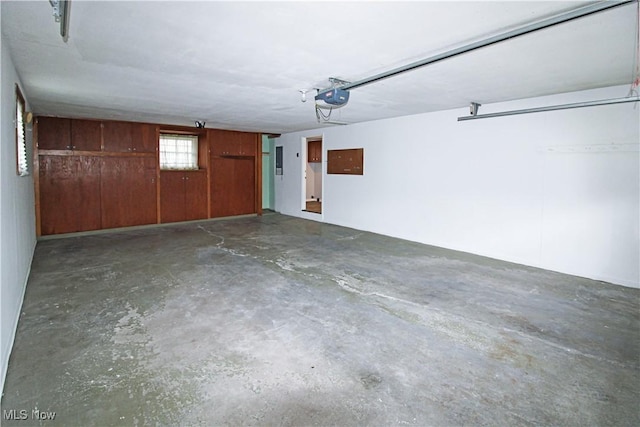 garage featuring wood walls and a garage door opener