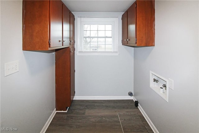 washroom with cabinets, hookup for a washing machine, and dark hardwood / wood-style flooring