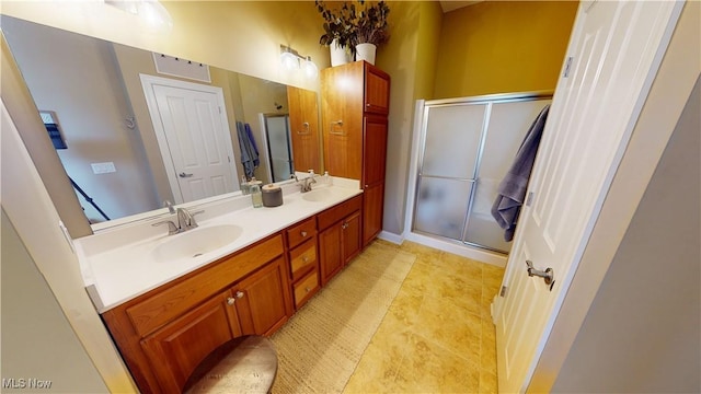 bathroom with tile patterned floors, vanity, and a shower with shower door