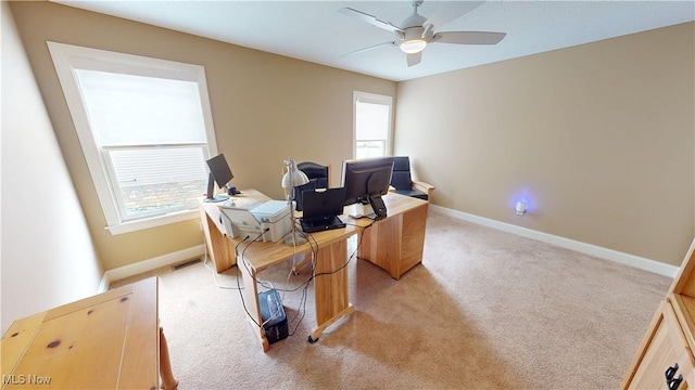 office space featuring ceiling fan and light carpet