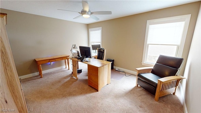 home office featuring light carpet and ceiling fan